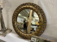 A gilt framed round mirror