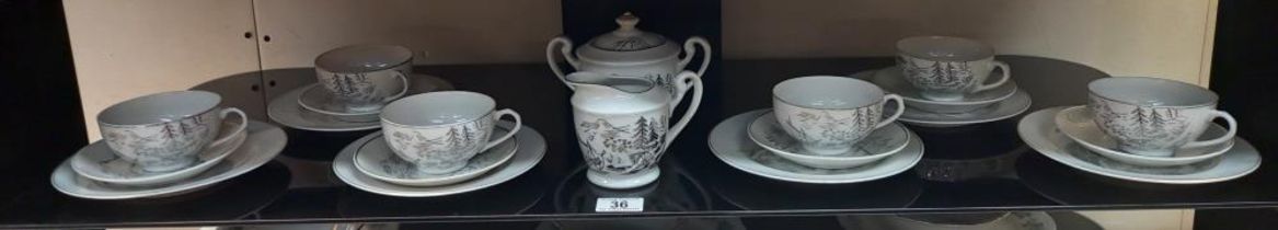 A 20 piece Japanese tea set with Geisha girl face in the bottom of cup COLLECT ONLY