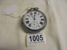 A large silver pocket watch marked L Baker, in working order.