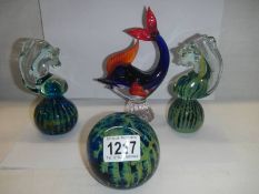 Two Mdina style seahorse paperweights and two others.