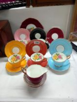 A set of 6 multicoloured Edwardian china cups and saucers with 22ct detail along with a cake