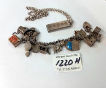 A silver charm bracelet & silver ingot (total weight 100gms)