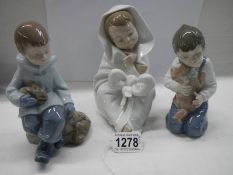 Three NAO by Lladro figures.
