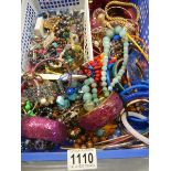 A large tray of assorted costume jewelry.