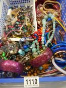 A large tray of assorted costume jewelry.