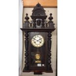 A Kienzle oak wall clock with key 76x31cm