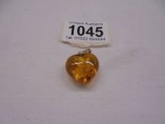 A 14ct gold set amber heart pendant.