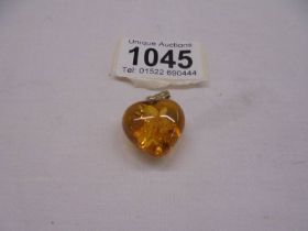 A 14ct gold set amber heart pendant.