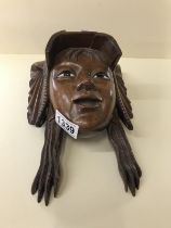 A fine carved head or a young girl (wall hanging)