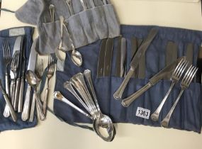 12 teaspoons, knives, forks, 6 spoons all marked MV & a bag of mixed cutlery