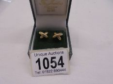 A pair of 9ct gold earrings in a ribbon design