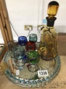 An interesting glass mirrored tray with 6 glass coloured goblets and a Carafe (possibly all