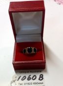 A 9ct gold ring wit dark blue stones, Size O (3.6g)