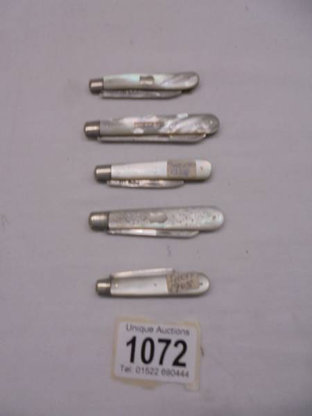 Five silver and mother of pearl fruit knives.