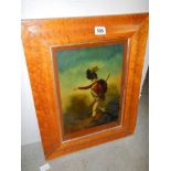 A reverse painting on glass of a soldier in a birds eye maple frame. COLLECT ONLY