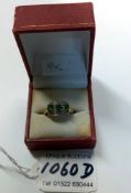 A 9ct gold rung with emeralds and diamonds, size N