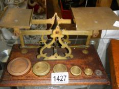 A set of Victorian brass postal scales with weights.