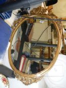 An oval gilt framed mirror, COLLECT ONLY.