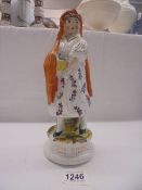 A 19th century Staffordshire figure of Little Red Riding Hood