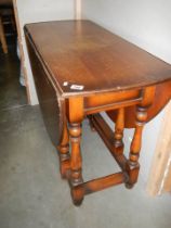 An oval oak gate leg table with barley twist supports, COLLECT ONLY.
