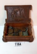 A decorative box with ship design & contents including Victorian coins & cyma miniature clock