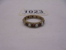 A ruby and opal yellow gold eternity ring, size M, 2.5 grams