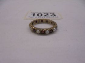 A ruby and opal yellow gold eternity ring, size M, 2.5 grams