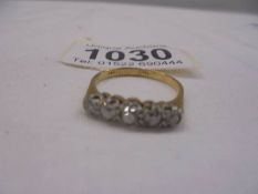 An 18ct five stone yellow gold diamond ring, size R, 2.9 grams.