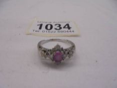 An 18ct white gold pink sapphire and diamond ring, size N, 3.6 grams.