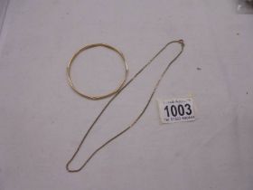 A 9ct gold bangle and a 9ct gold neck chain, 16.69 grams.