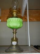 A Victorian oil lamp with green glass font, in good condition, COLLECT ONLY.