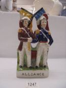 A rare and unusual Staffordshire figure entitled 'The Alliance' depicting two soldiers holding flags