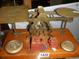 A set of Victorian brass postal scales with weights.