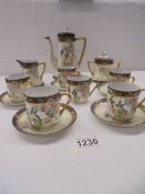 A hand painted Japanese porcelain coffee set, (Missing one saucer).