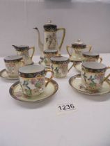 A hand painted Japanese porcelain coffee set, (Missing one saucer).