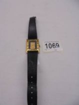 A Credit Suisse wrist watch with a 1 gram .999 gold ingot in centre.