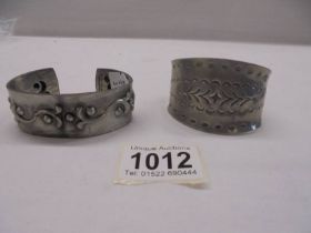 A Jorgen Jensen pewter cuff and one other.