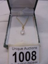 A 9ct gold pendant set white stone on a 9ct gold chain, 1 gram.