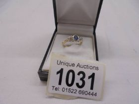 A 9ct gold oval sapphire with three diamonds ring, size L, 2.3 grams.