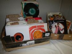 Two boxes of 45 rpm records.