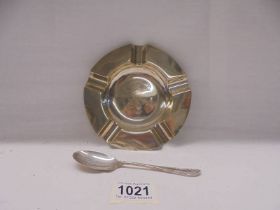 A solid silver ashtray dated 1910 and a silver teaspoon.