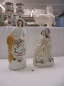 A large Staffordshire figure of a woman A/F and another of a young couple.