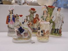 Five 19th century Staffordshire figures and spill vases, Poacher in good condition, other four a/f.