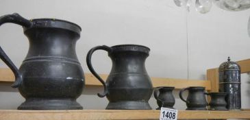 A quantity of old pewter tankards etc.,
