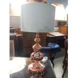 A copper table lamp.