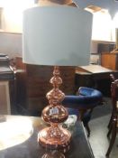 A copper table lamp.