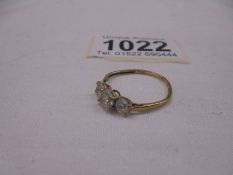 A three stone 9ct yellow gold ring, size M, 1.4 grams.