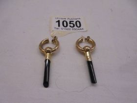 A pair of 9ct gold pendant earrings with onyx drops, 5 grams.