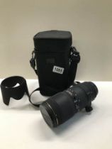 A Sigma camera lens in case,