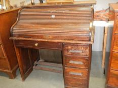 An early 20th century single pedestal roll top desk in fair condition, COLLECT ONLY.